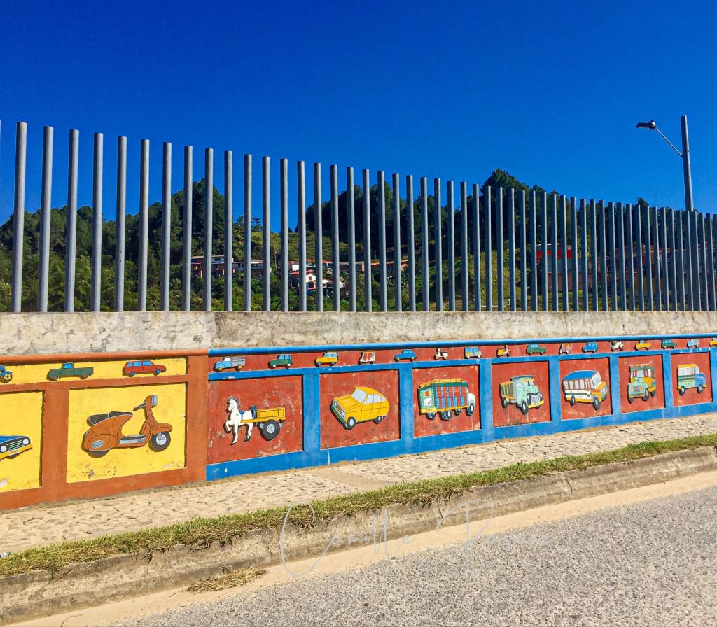 A wall decorated with colourful facades is a typical scene in Guatape